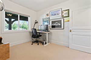 Home office featuring baseboards and carpet flooring