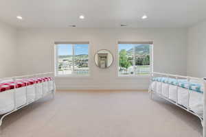 Bedroom featuring light colored carpet, visible vents, baseboards, and recessed lighting