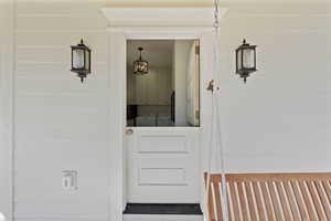 Doorway to property featuring separate washer and dryer