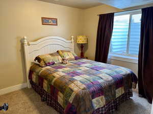 Carpeted bedroom featuring baseboards