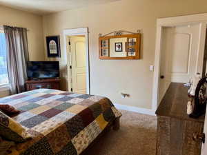 Carpeted bedroom featuring baseboards