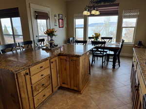 Kitchen featuring tile patterned flooring, decorative light fixtures, and a lake & mountain view