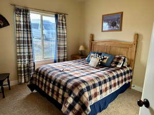 Carpeted bedroom with baseboards