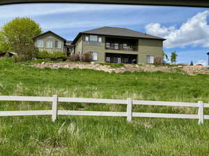 Back of property with a balcony