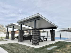 View of patio with area for grilling and fence