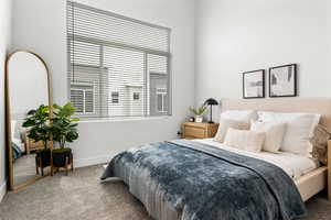 Carpeted bedroom featuring baseboards