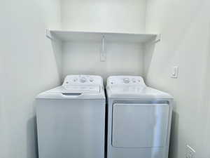 Washroom with washer and dryer and laundry area