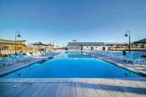 Community pool with fence and a patio area