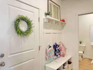 Mudroom with baseboards and wood finished floors