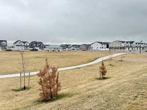 View of yard with fence and a residential view