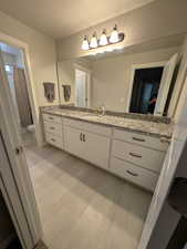 Full bathroom featuring toilet, wood finished floors, vanity, and a textured ceiling
