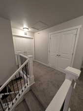 Stairway featuring baseboards, visible vents, carpet flooring, and a textured ceiling