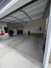 Garage with electric panel and a garage door opener