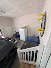 Garage featuring freestanding refrigerator