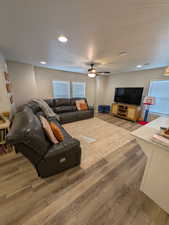 Living room featuring wood finished floors, recessed lighting, and a ceiling fan