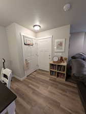 Entryway with visible vents, a textured ceiling, and wood finished floors