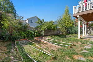 View of yard with a fenced backyard and a garden