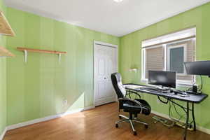 Home office with baseboards and wood finished floors