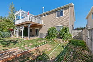 Back of house with central air condition unit, a wooden deck, a fenced backyard, a patio, and a vegetable garden