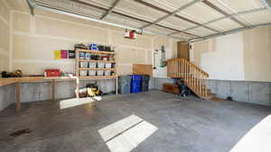 Garage featuring a garage door opener and a workshop area