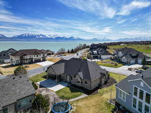Drone / aerial view featuring a water and mountain view and a residential view
