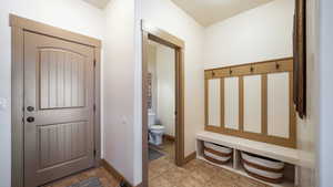 Mudroom with light tile patterned flooring and baseboards