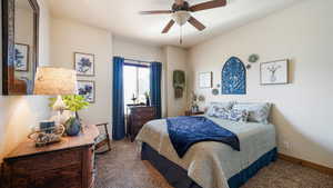 Bedroom featuring baseboards, carpet flooring, and ceiling fan