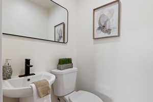 Half bathroom with toilet and a sink