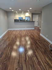 Living room featuring recessed lighting, baseboards, and dark wood finished floors.  Please note that the condo is fully furnished.
