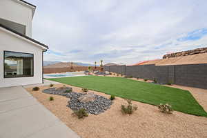 View of yard featuring a fenced in pool, a fenced backyard, and a patio area