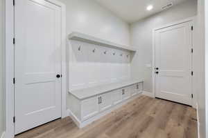 Mudroom with baseboards, visible vents, recessed lighting, and light wood-type flooring