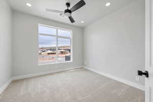 Spare room with baseboards, carpet flooring, visible vents, and a ceiling fan