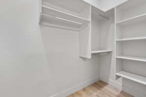 Spacious closet featuring wood finished floors