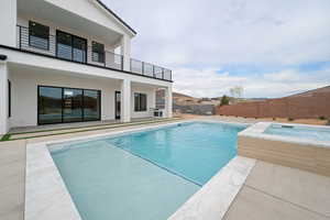 View of pool with a fenced backyard, an in ground hot tub, a patio, and a fenced in pool