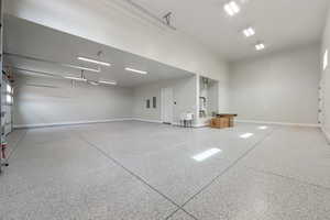 Garage featuring a sink and baseboards