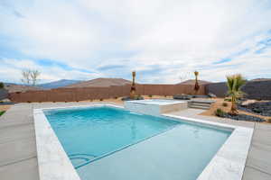 View of pool with a fenced backyard, a fenced in pool, area for grilling, an in ground hot tub, and a patio area