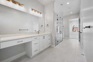 Full bathroom with a shower stall, baseboards, visible vents, and vanity
