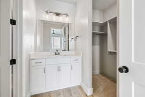 Bathroom with vanity and baseboards