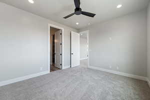 Unfurnished bedroom with baseboards, a spacious closet, recessed lighting, and carpet flooring