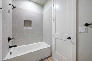 Full bath featuring bathing tub / shower combination and wood finished floors