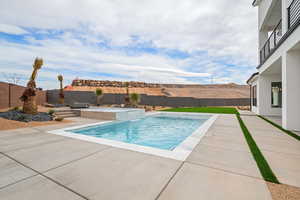 View of pool featuring a fenced backyard, a patio area, a mountain view, and a fenced in pool