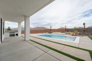 View of pool featuring a patio, a fenced in pool, a fenced backyard, and an in ground hot tub