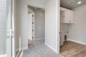Laundry room with baseboards, visible vents, and electric dryer hookup