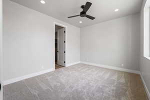 Carpeted empty room with baseboards, recessed lighting, and a ceiling fan