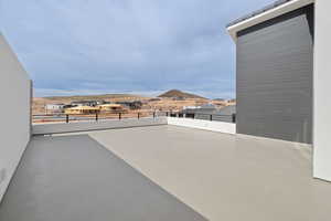 View of patio featuring a balcony and a mountain view