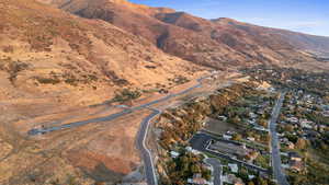 Aerial view of property and surrounding area with a mountainous background