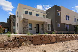 Contemporary home with stone siding and stucco siding