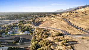 Aerial view of property's location with mountains and nearby suburban area
