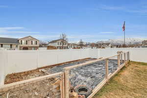 View of yard featuring a garden, a residential view, and a fenced backyard