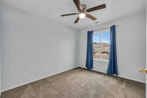 Unfurnished room featuring a ceiling fan, carpet floors, baseboards, and visible vents